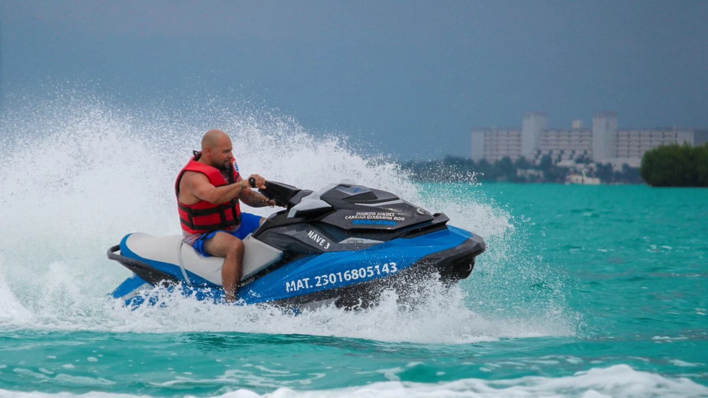 A young man drives a jet ski in the sea, rented from Jet Ski Cancun