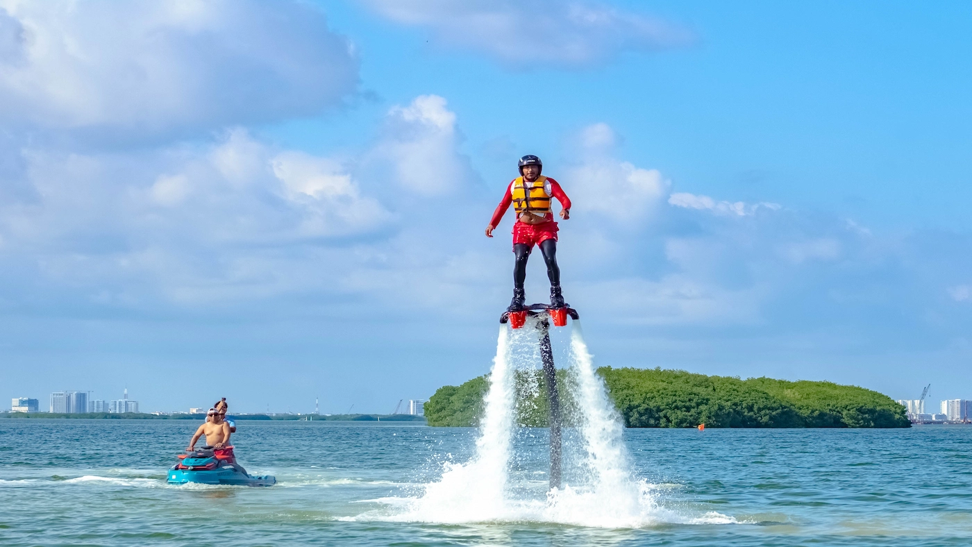 Adventurer enjoying the Cancun Flyboard Experience, flying above the waters of the Nichupte Lagoon in Cancun, Mexico